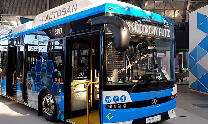 Electric or hybrid city bus presented indoors during exhibition