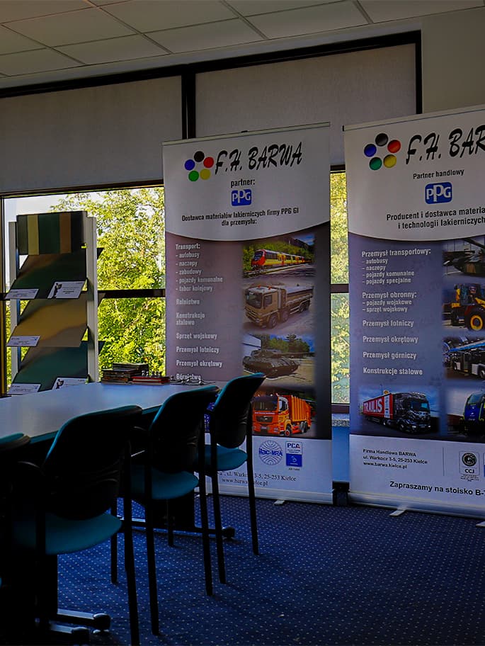 Exhibition of F.P. Barwa advertising banners in conference room. Visible roll-ups presenting company offer, training chairs and tables in background.